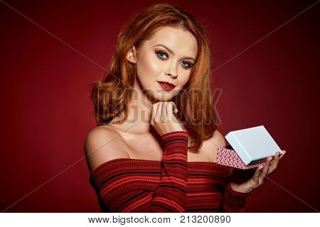 Happy woman in excitement opening Christmas box 