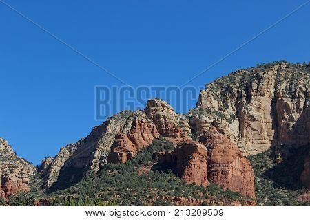 Jagged red rocks of Boynton Canyon in Sedona Arizona on a sunny day with clear blue skies