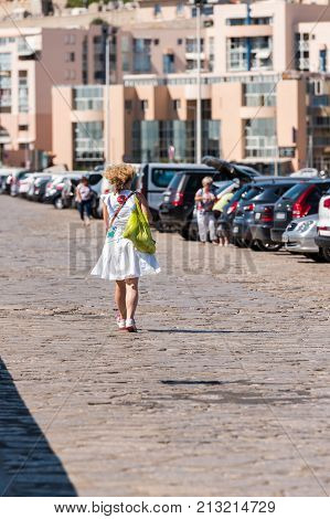 Woman On The City Quay In Sete, France. Copy Space For Text. Vertical
