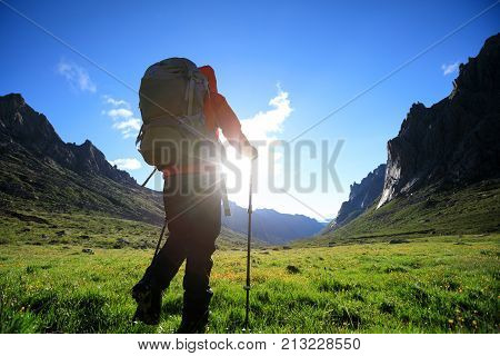 woman with backpack hiking in mountains travel lifestyle success concept adventure active vacations outdoor mountaineering sport sunrise landscape