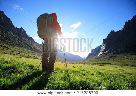 woman with backpack hiking in mountains travel lifestyle success concept adventure active vacations outdoor mountaineering sport sunrise landscape