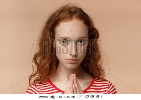Horizontal Headshot Of Young Pretty Redhead European Woman Isolated On Peach Background Holding Palm