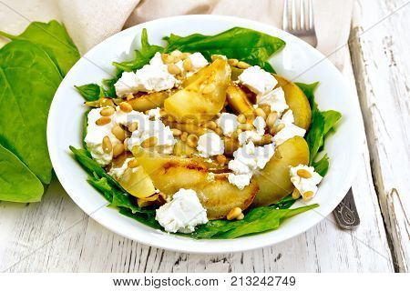 Salad From Pear And Spinach In Dish On Board