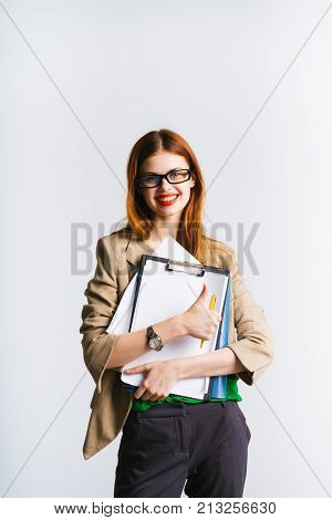 happy stylish girl with glasses, with red lipstick holds documets in hands, smiling