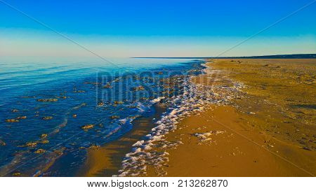Sea foam at the beach of the Aral Sea near Aktumsuk cape at sunset in Karakalpakstan Uzbekistan