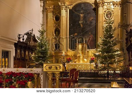 WARSAW, POLAND - JANUARY 02, 2016: Main altar of the Roman Catholic Church of the Holy Cross (XV-XVI cent.) in Christmas decorations. Is a one of the most notable Baroque churches in Poland's capital.