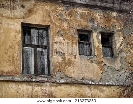 Fragment of the wall of a very old residential building. Apartment block. Historical heritage. Old architecture. Old city