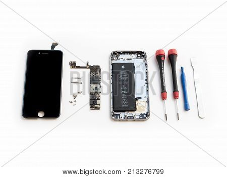 Chiangrai Thailand: September 13 2017 - Disassembled broken Apple iPhone 6 space gray color preparing to repair or replace new part on white background.