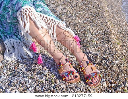 leather greek sandals advertisement on the beach - bohemian style clothing