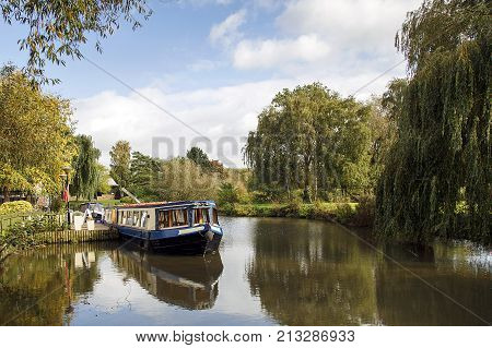 Narrow boat moored on the Avon canal awaiting tourists to cruise down the river through Stratford upon Avon