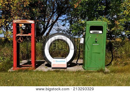 DOWNER, MINNESOTA, October 3, 2017: The tire between old gas pumps was an American tire company know as BFGoodrich Co. is now part of tire maker Michelin.