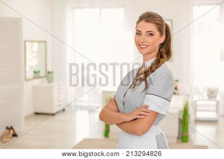 Beautiful chambermaid in room