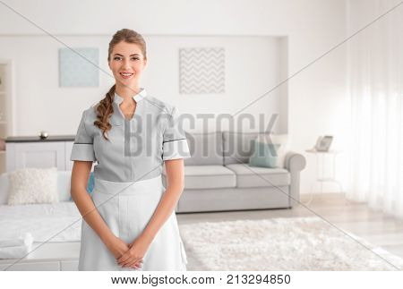 Beautiful chambermaid in room