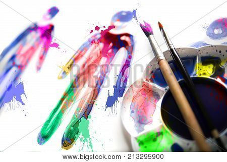 Abstract people made of watercolour  palette and artist brushes
