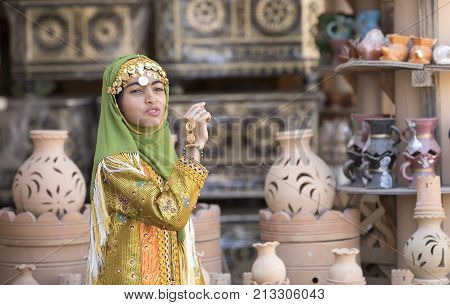 Nizwa Oman November 10th 2017: omani girl dressed in traditional cloting singing