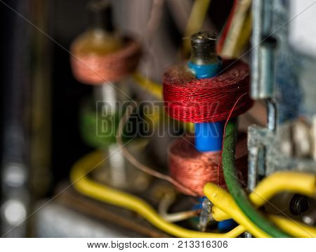 Colorful details of the electronic interior of an old transistor radio.