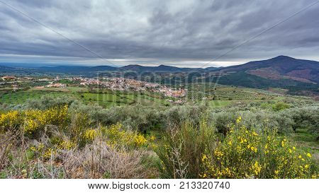 Detailed view of Guadalupe abbey and village against cloudy sky