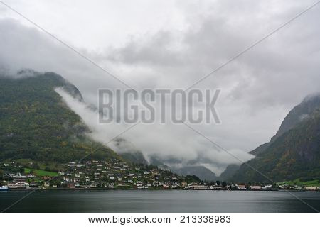 Flam is a village in Flamsdalen at the inner end of the Aurlandsfjorden a branch of Sognefjorden. The village is located in the municipality of Aurland in Sogn og Fjordane county Norway.