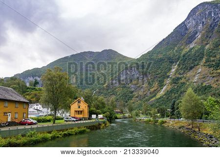 Flam is a village in Flamsdalen at the inner end of the Aurlandsfjorden a branch of Sognefjorden. The village is located in the municipality of Aurland in Sogn og Fjordane county Norway.