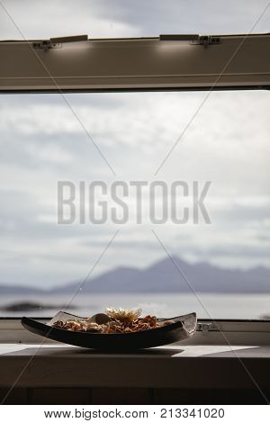 Bowl Of Pot Pourri With Landscape In The Background Lit By The Sun, Portrait Orientation