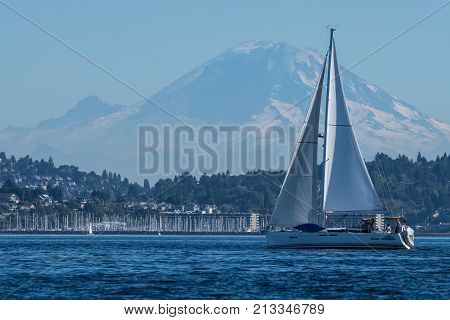 Sailing Vessel One Man Wolfpack transiting Seattle's Shilshole Bay with Mount Rainier in the backgrounds