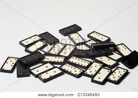White and black domino pieces on wnite background