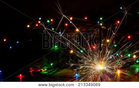 Sparkler and Christmas lights as an ideal background