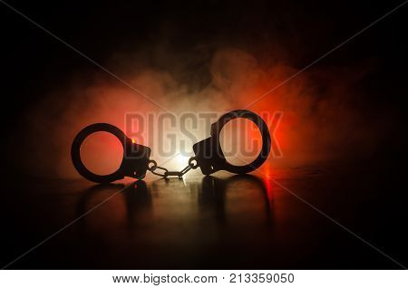 Handcuff Or Shackle On Black Background. Silhouette Of Shackle On Dark Background