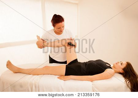 Physiotherapist Doing Tecar Therapy Alterantive Treatment On A Woman Patient