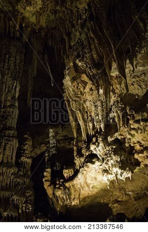 Vertical close up view of the amazing cavern speleothems mostly stalactite stalagmite formations with warm lighting at the Luray Caverns, Virginia located in the Shenandoah Valley.