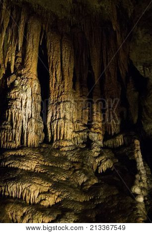 Vertical close up view of the amazing cavern speleothems mostly stalactite stalagmite formations with warm lighting at the Luray Caverns, Virginia located in the Shenandoah Valley.