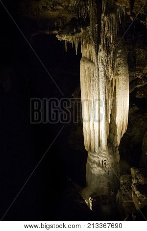 Vertical close up view of the amazing cavern speleothems mostly stalactite stalagmite formations with warm lighting at the Luray Caverns, Virginia located in the Shenandoah Valley.