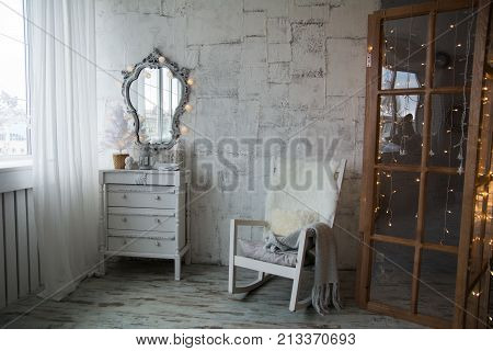 An Old-style Room With A Mirror And Rocking Chair