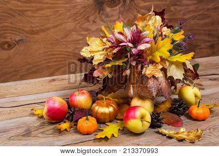 Thanksgiving Table Centerpiece With Golden Pumpkin And Leaves