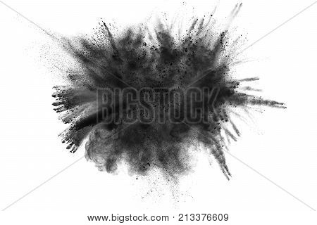 The particles of charcoal splatted on white background.Black powder explosion. Closeup of black dust particles explode isolated on white background.