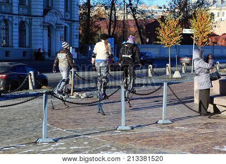 St. Petersburg, Russia - October 27, 2012: Three girls go on stilts on the Petrograd embankment