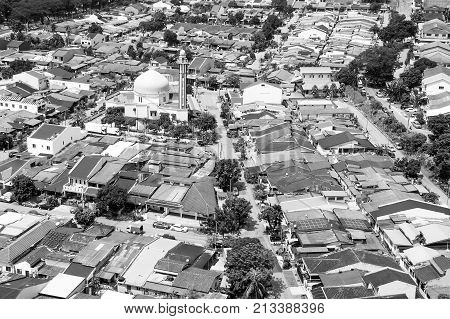 Aerial view of mosque surrounded in suburb of Kuala Lumpur black and white