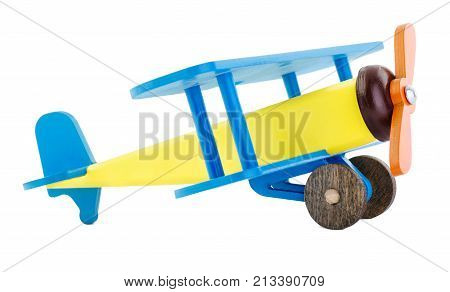 A mock child's bright airplane made of wood isolated on white background. Side view. Corncorn. The concept of children's toys. Retro Toys