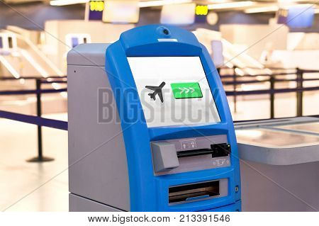 Self service machine and help desk kiosk at airport for check in printing boarding pass or buying ticket.