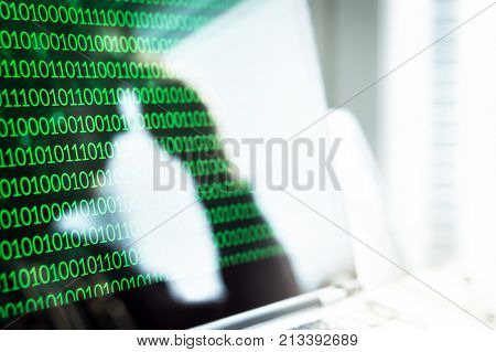 Cyber bullying online fraud or computer virus concept. Reflection of sad depressed and frustrated man or teen leaning head on hand in laptop screen. Victim of identity theft or email scam.