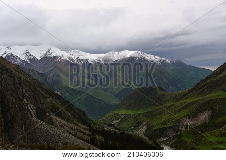 Beautiful landscape in mountains of Kyrgystan (snow, sky, cloudy)
