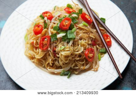 Asian noodles with bean prouts, spring onion and chili pepper