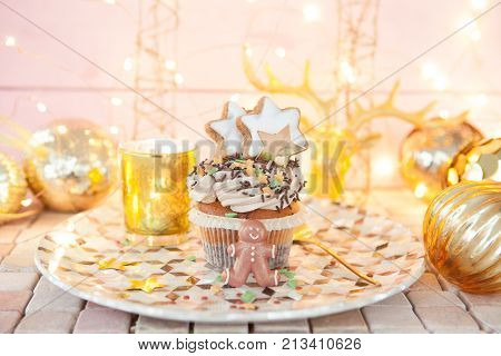 Little christmas cupcake with sugar decorations and cream frosting