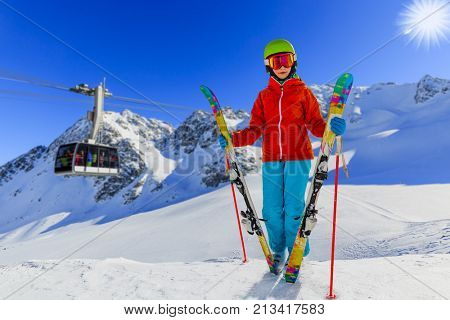 Beautiful girl enjoying winter vacation on snow in sunny cold day in mountains  Cable car in Verbier, Mont Fort, 4 Valleys Switzerland.