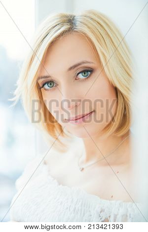 Portrait of a young blonde woman with blue eyes