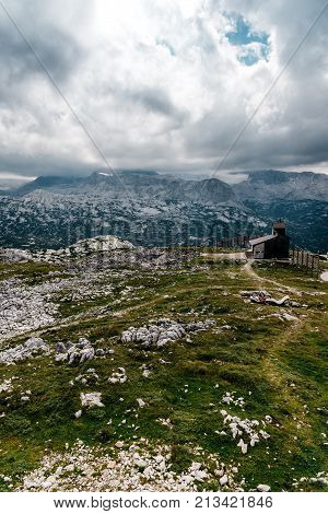 Scenic view of alps mountains a sunny day with church on foreground. Hoher Dachstein mountains.