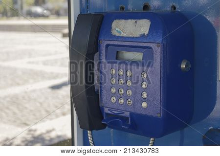 Old blue telephone set on the street