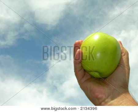 La manzana verde en la mano