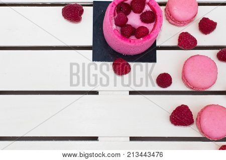 Rasperry charlottemacaroons raspberry berries on a tray of white boards