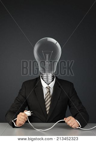 Businessman with light bulb head and plug switch ideas creative concept on black